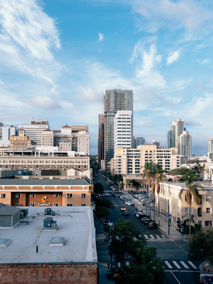 High angle view of San Diego's bustling downtown with skyscrapers under a bright sky.