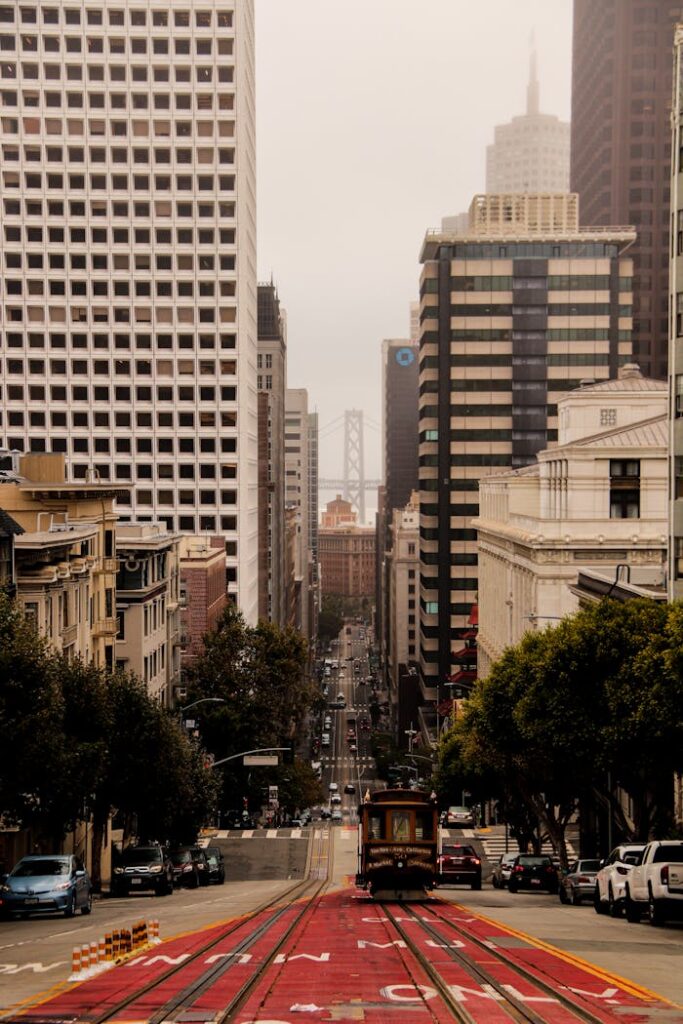 Foggy view of San Francisco street featuring the iconic tram and urban architecture.