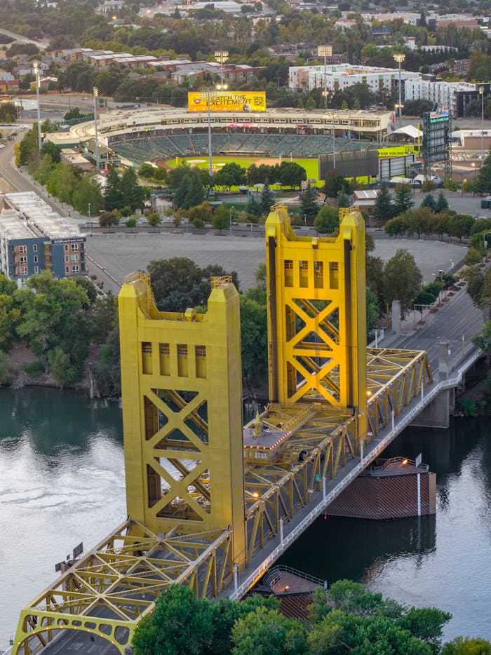 A captivating aerial shot featuring Sacramento's iconic Tower Bridge and Sutter Health Park.