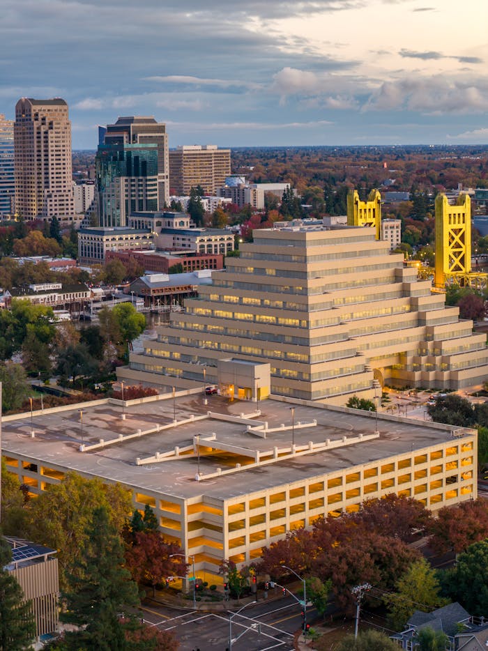 Stunning aerial view of Sacramento's Ziggurat Building at sunset, showcasing urban architecture.